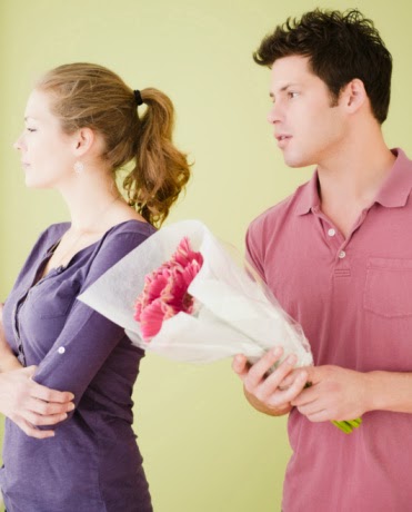 Man offering unhappy girlfriend flowers