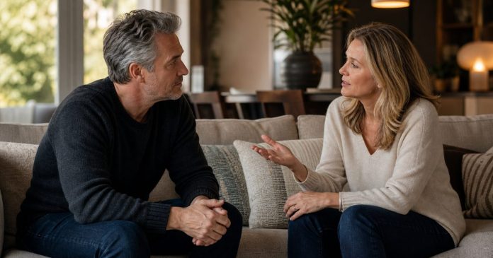 Married couple having a calm, respectful conversation on a sofa